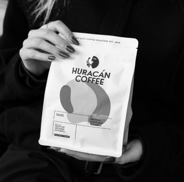 Customer holding a bag of Huracán Coffee